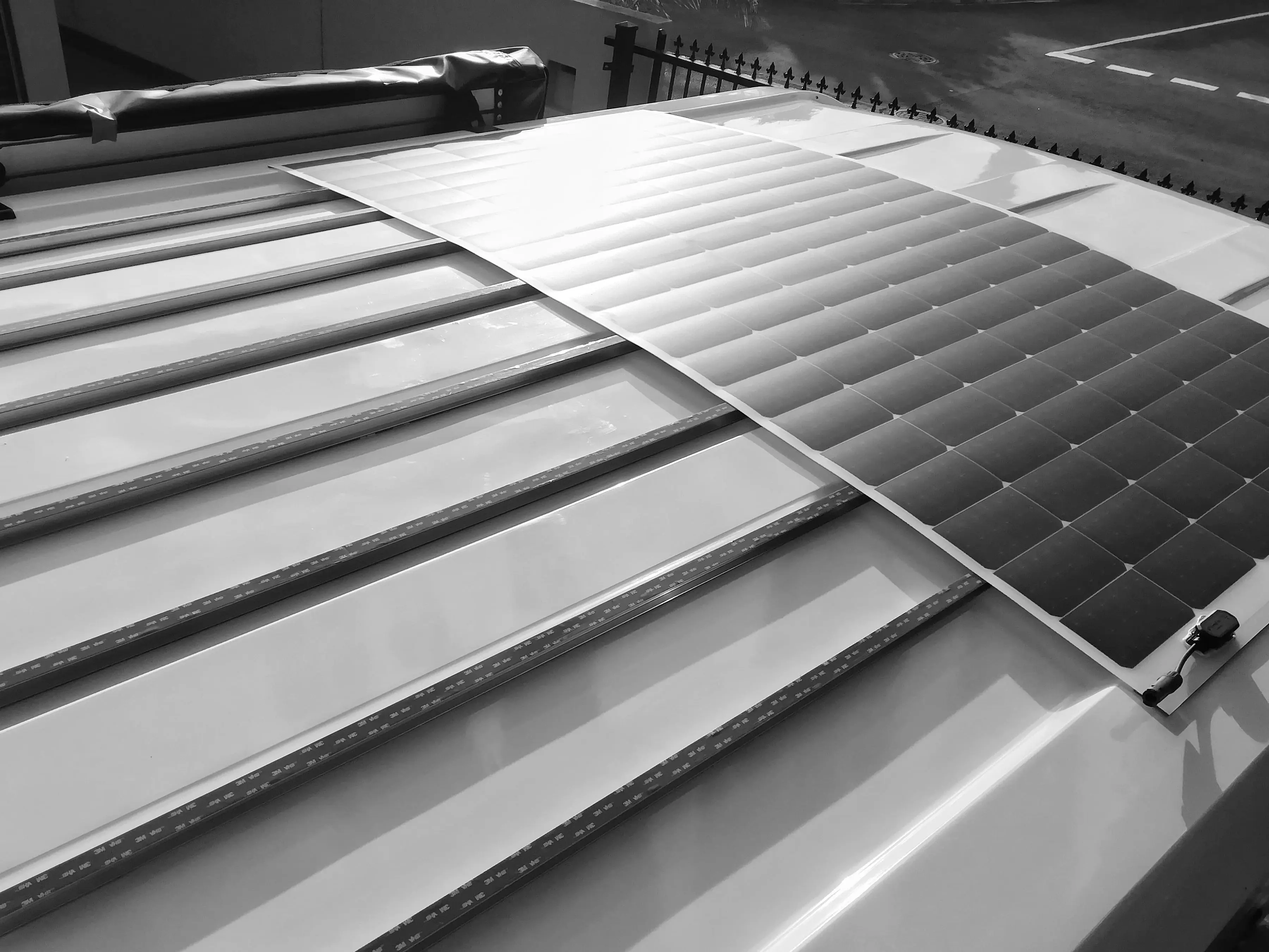 Attaching 760W rooftop flexible PV array to curved roof of caravan with proprietary method (in progress)..